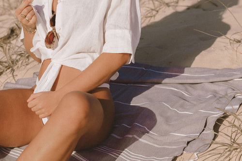 Girl sitting on charcoal Turkish Towel