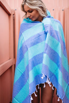 Girl with green and blue Turkish towel around her